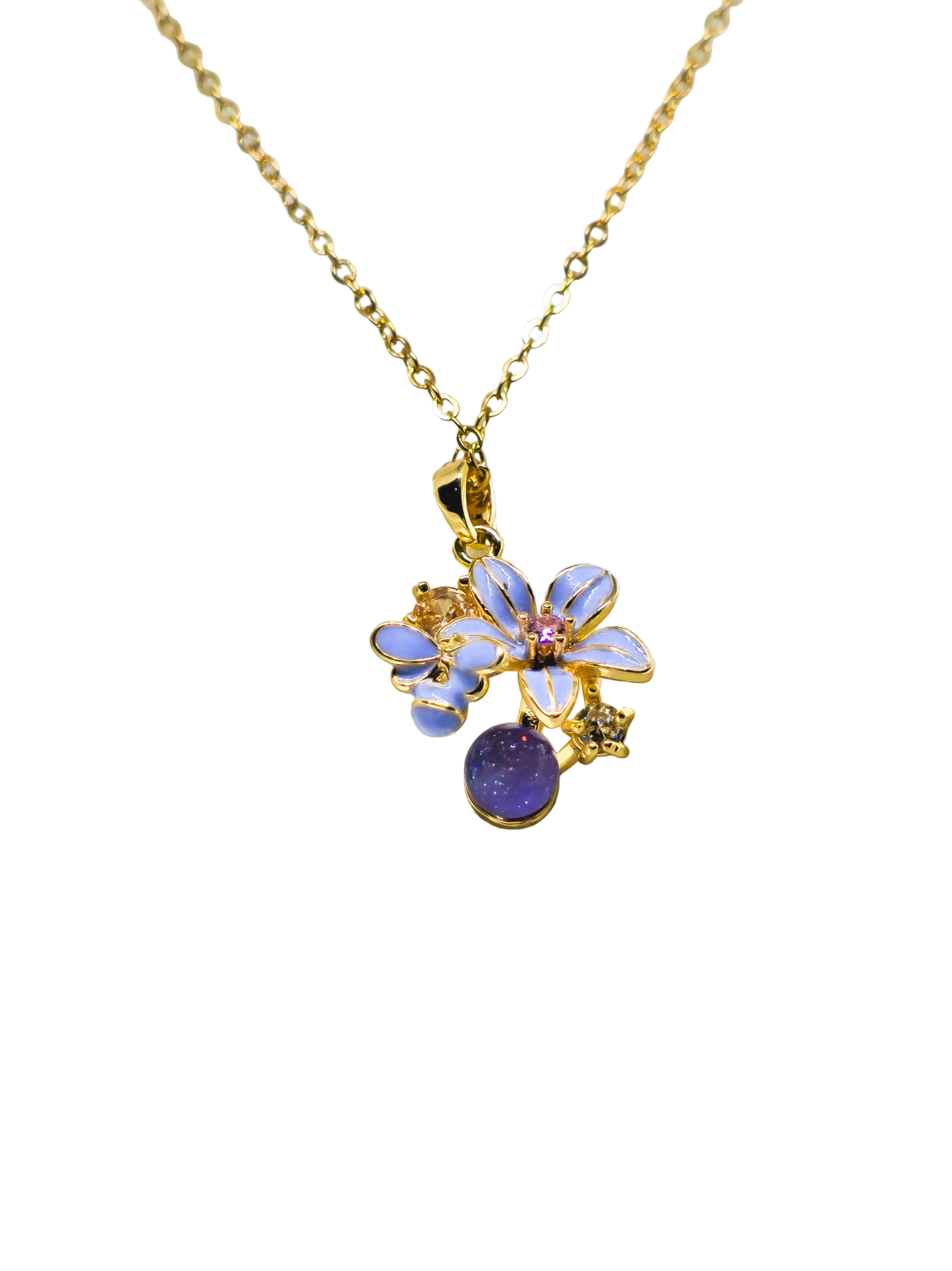 Gold necklace with a floral pendant on a white satin background